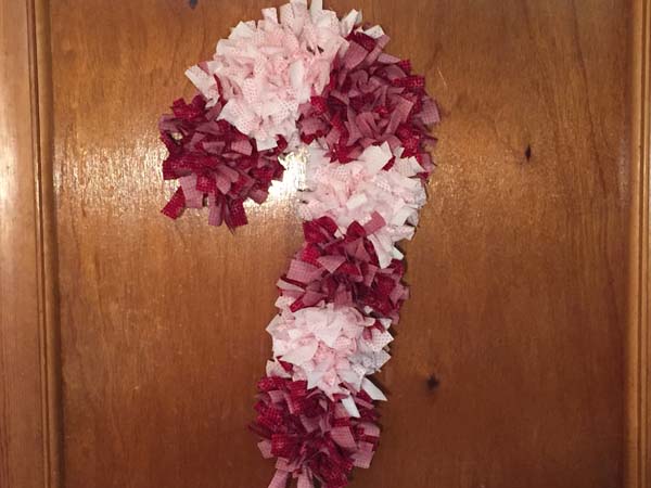 Candy Cane Rag Wreath Hanging On Inside Door