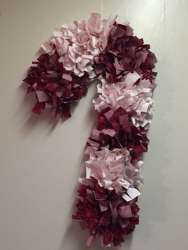 Candy Cane Rag Wreath Hanging On Wall