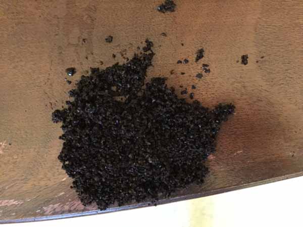 Conceal Furniture Scratches with Coffee Grounds - Grounds on Table