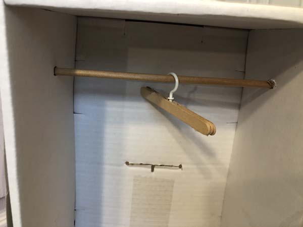 Doll Clothes Hanger Hanging On Rod