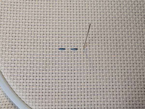 Holbein Stitch Up from back two holes forward