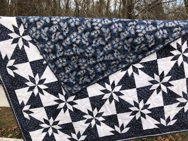 Hunters Star Quilt Completed Quilt On Fence showing backing