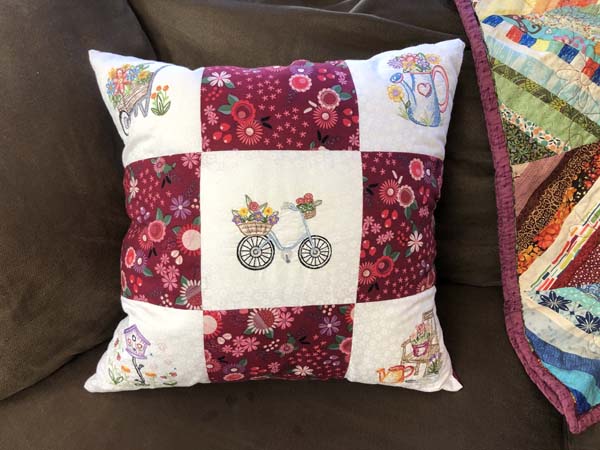 Machine Embroidered Nine Patch Pillow on couch closer