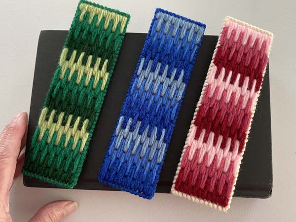 Ombre Boomark 25 three finished bookmarks on book