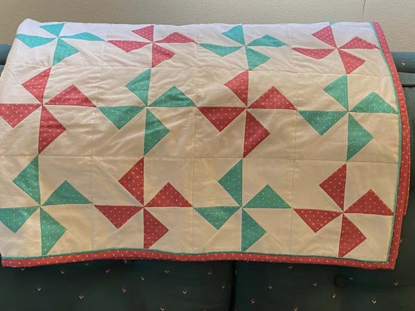 Pinwheel Quilt Folded On Couch Closer
