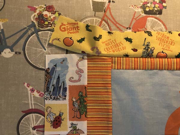 Scrappy Panel Quilt Last Border Added showing partial seam from top border