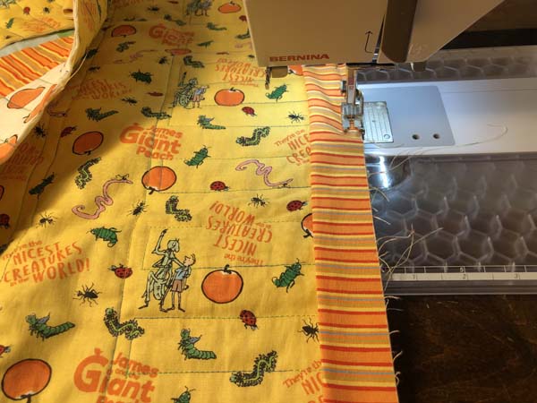 Scrappy Panel Quilt Sewing on Binding