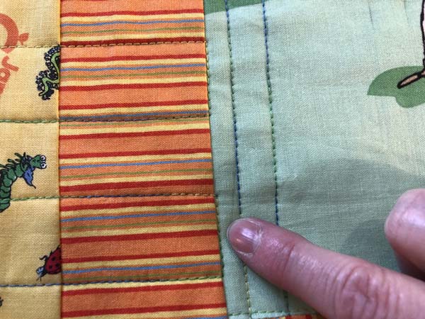 Scrappy Panel Quilt Showing Stitch in the ditch connecting lines