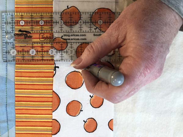 Scrappy Panel Quilt Using Chalk to mark lines