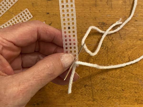 Snowflake Christmas Ornament wrap yarn around and come up through second hole