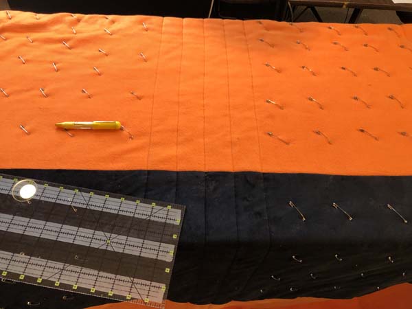 Straight Line Quilting Showing Pinned Quilt with a few lines quilted