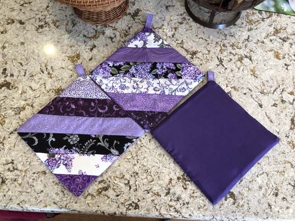 String Pieced Potholders in Purples one showing back