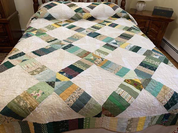 Totally Scrappy Quilt on Bed