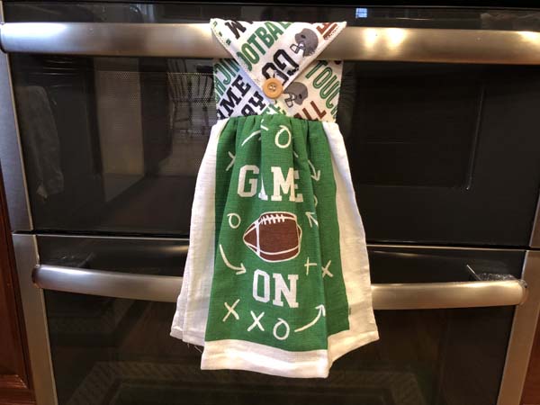 Washcloth Towel Finished with Button Hanging on Stove Handle