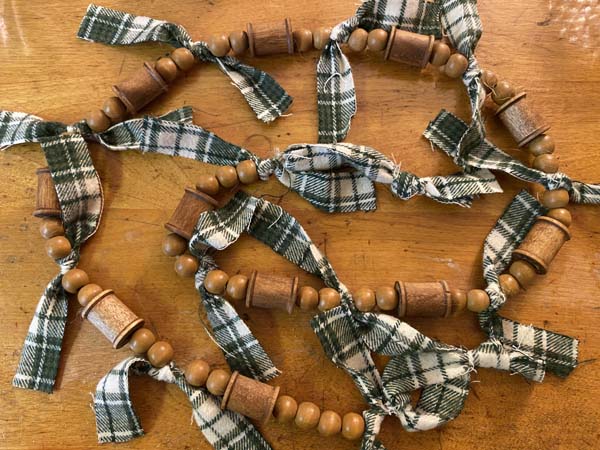 Wood Thread Spool and Bead Garland Finished on Table