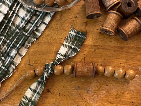Wood Thread Spool and Bead Garland Tie Fabric