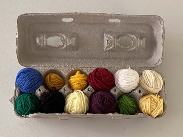 Yarn Unraveling 7 Yarn Balls in Egg Carton